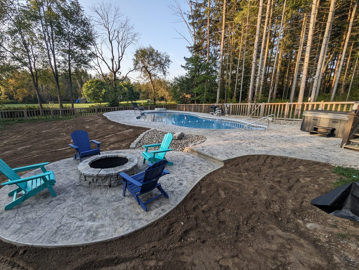 Stamped concrete pool deck and fire pit patio installed in Syracuse NY by Xtreme Companies