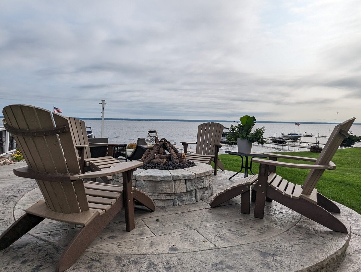 Lakeside fire pit patio with stamped concrete in Central New York