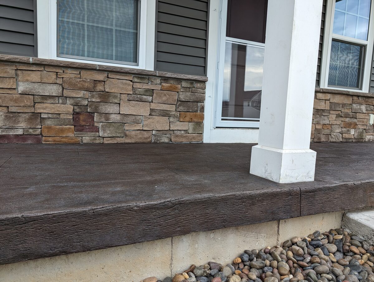 Wood plank stamped concrete front porch with stone veneer in Syracuse NY