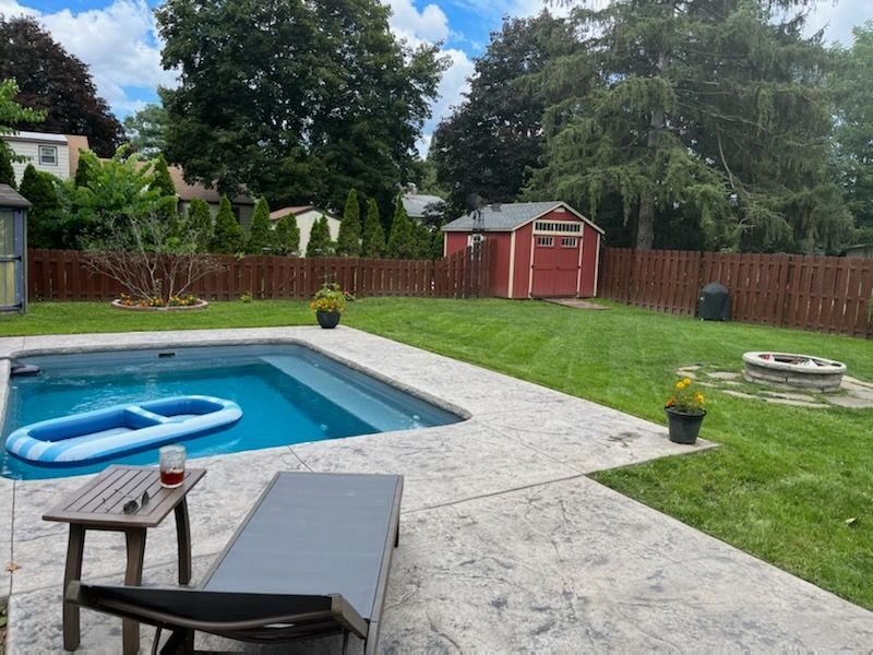 Stamped concrete pool deck with natural stone pattern in Syracuse NY