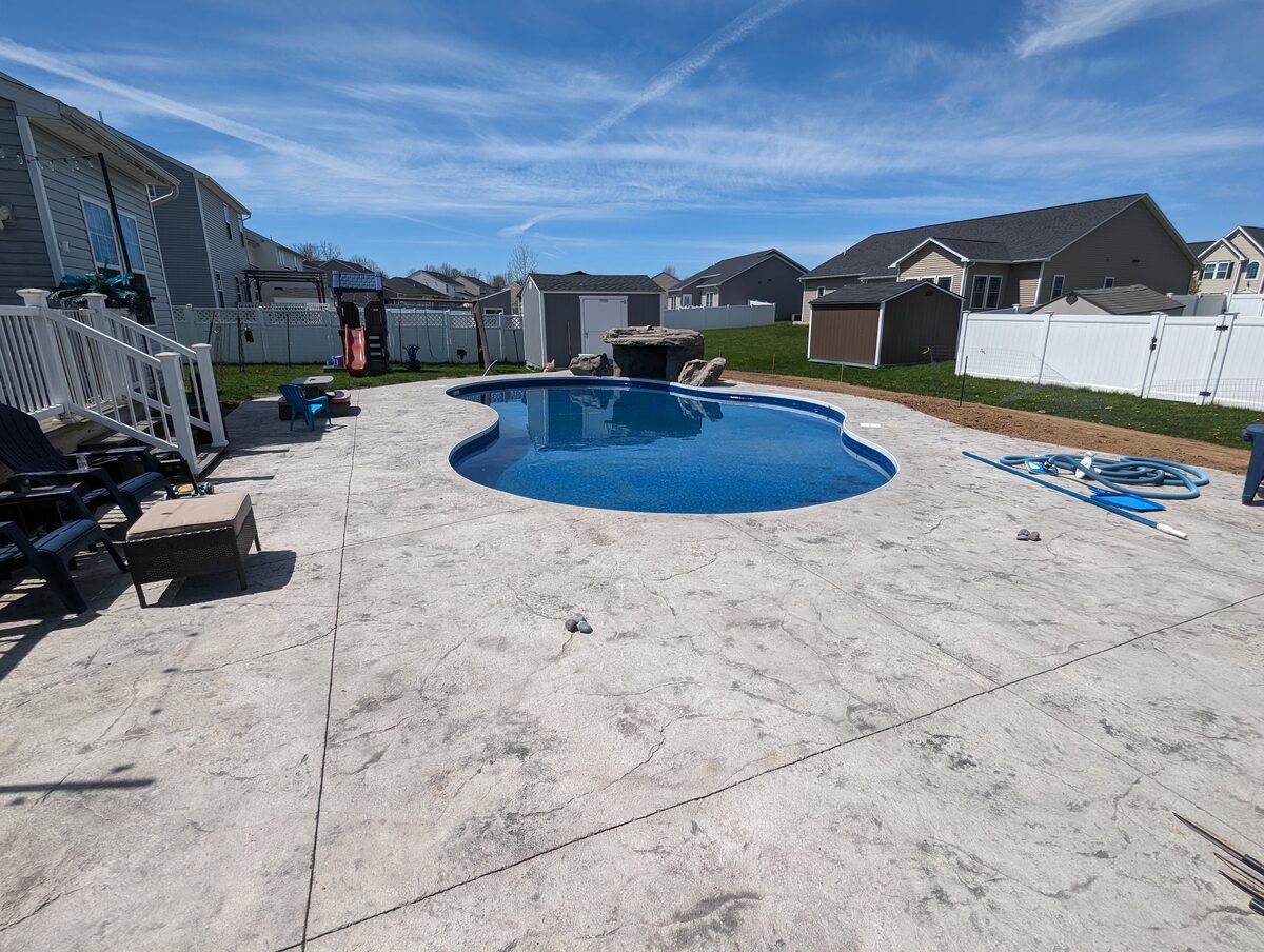 Large stamped concrete pool deck installation in a Syracuse NY backyard