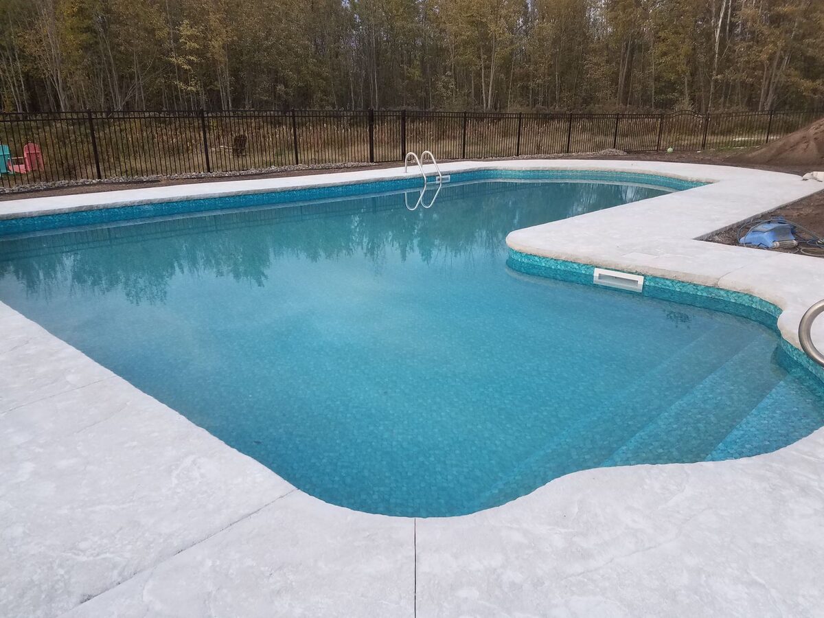 Decorative stamped concrete pool surround completed in Central New York