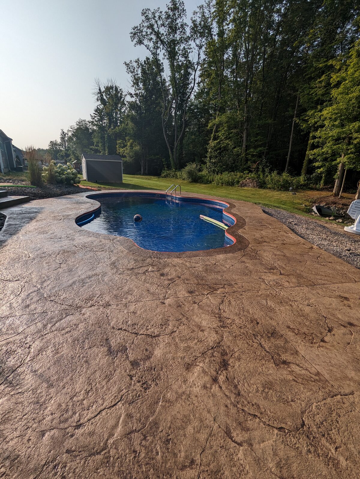Stamped concrete pool deck with natural texture finish in Syracuse NY